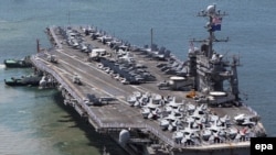 The U.S. nuclear-powered aircraft carrier "USS George Washington" moves to come alongside the pier at a port in Busan, southeast of Seoul, on July 21.