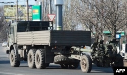 An artillery gun of the self-proclaimed "People's Republic of Donetsk" is towed in Donetsk in March.