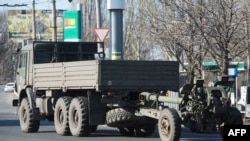 An artillery gun of the self-proclaimed "People's Republic of Donetsk" is towed in Donetsk in March.