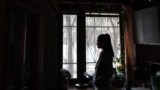 Russia -- Aleksandra, 26, a victim of domestic violence, poses for pictures in a kitchen at a flat in Moscow, February 3, 2017