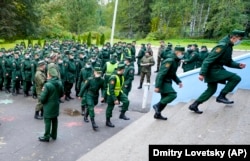 Russian Army soldiers wait outside a polling station in St. Petersburg on September 17.