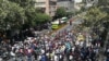 Iranian protesters shout slogans during a protest against the economic conditions in central Tehran, June 25, 2018