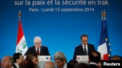 France -- French President Francois Hollande (R) and Iraqi President Fuad Masum attend the opening of an international conference on fight against Islamic State in Paris, September 15, 2014