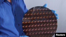 A silicon wafer containing chips made with IBM Corp's 2-nanometer transistor technology, May 6, 2021. 