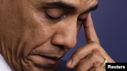 U.S. President Barack Obama wipes a tear as he speaks about the shooting at Sandy Hook Elementary School.