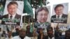 Supporters of the All Pakistan Muslim League (APML), the party of former military ruler Pervez Musharraf, carry placards during a protest following his conviction in a treason case on December 17.