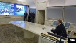 Russian President Vladimir Putin watches a live broadcast of the launch from the Plesetsk cosmodrome in a presidential situation center in Moscow on December 23.