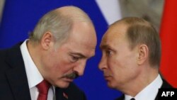Russian President Vladimir Putin (right) and his Belarusian counterpart Alyaksandr Lukashenka talk a signing ceremony at a session of the Supreme State Council of the Union State at the Kremlin in Moscow on March 3.