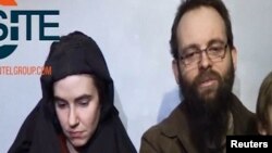 A video posted by the Taliban on social media on December 19, 2016 shows American Caitlan Coleman (left) speaking next to her Canadian husband, Joshua Boyle, and their two sons.