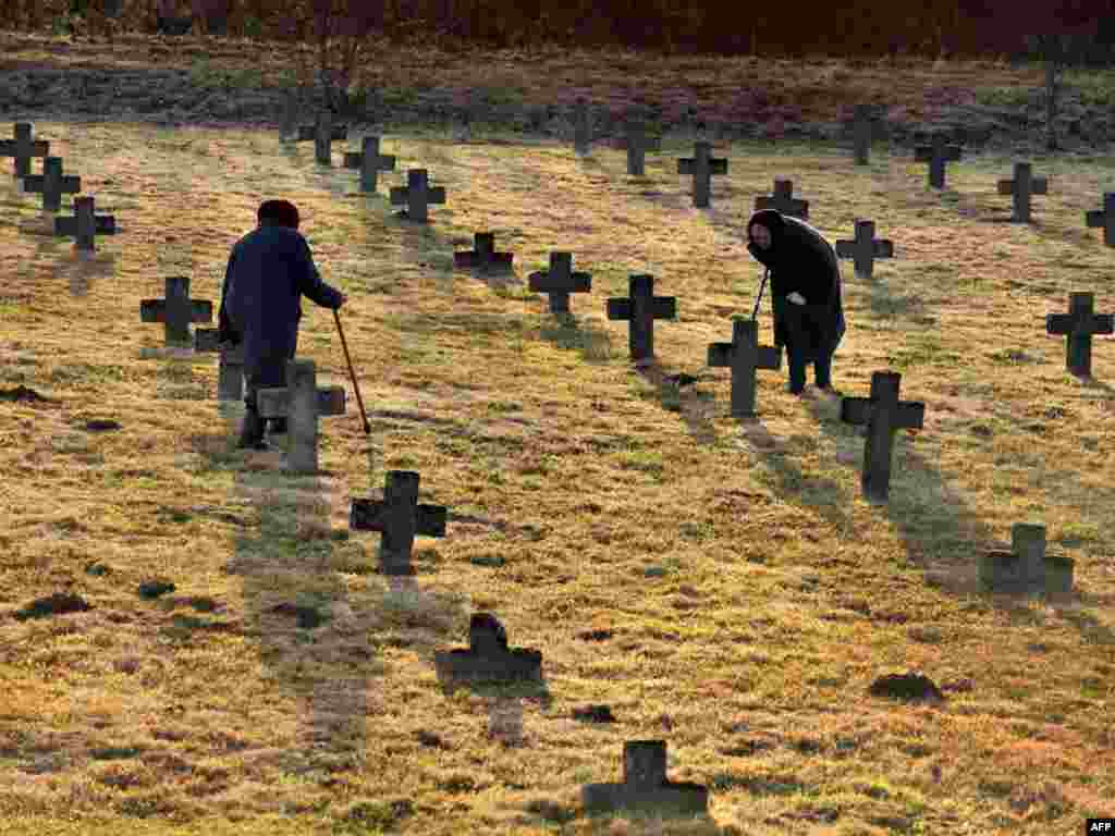Elderly women visit a cemetery near the Belarusian village of Baruny, some 100 kilometers northwest of the capital, Minsk, on November 1, marking the upcoming Dzyady (Remembrance Day or All Saints' Day). Photo by Viktor Drachev for AFP