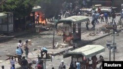 Islamist protesters and their supporters clash with armed men, after an attack on protesters the previous night, in Cairo on May 2.