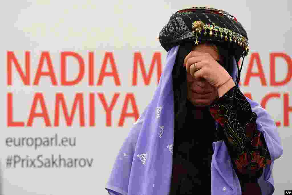 Nadia Murad Basee, a public advocate for the Yazidi community in Iraq and a survivor of sexual enslavement by Islamic State militants, reacts after being awarded -- along with fellow activist Lamiya Aji Bashar -- the 2016 Sakharov Prize For Freedom Of Thought on December 13 at the European Parliament in Strasbourg. (AFP/Fredereick Florin)