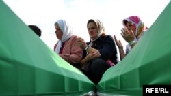 Coffins of newly identified victims during preparations for their mass burial at the Potocari memorial cemetery near Srebrenica