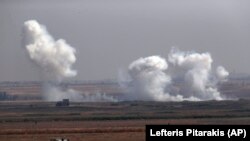 SYRIA -- In this photo taken from the Turkish side of the border between Turkey and Syria, in Akcakale, Sanliurfa province, southeastern Turkey, smoke billows from targets inside Syria during bombardment by Turkish forces Thursday, Oct. 10, 2019.