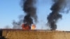 أعمدة الدخان تتصاعد من شاحنات الوقود التابعة لحلف الناتو وهي تحترق في باكستان.