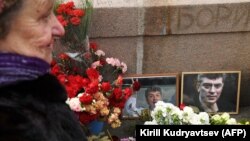 A woman lays flowers last month at a memorial near the site where Boris Nemtsov was killed in Moscow in 2015.