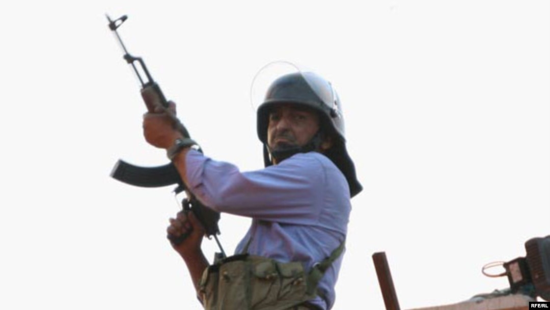 A Basij member stands on a rooftop in Tehran during the antigovernment protests on June 15, 2009.