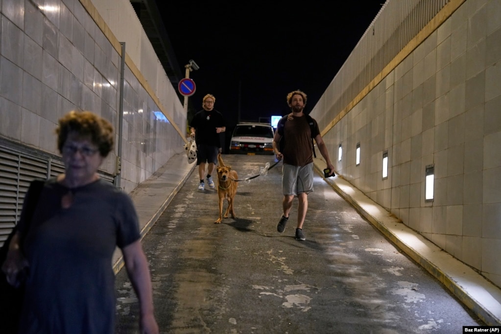 Izraelitë duke nxituar për t'u strehuar në një parking automjetesh, gjatë një alarmi për sulme raketore nga Irani, në Tel Aviv, më 17 qershor.