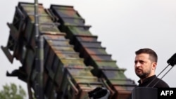 Ukrainian President Volodymyr Zelenskiy stands in front of a Patriot air-defense missile launcher in eastern Germany on June 11.