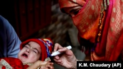 A health worker marks a child's finger after administering a polio vaccination in Lahore on January 11.