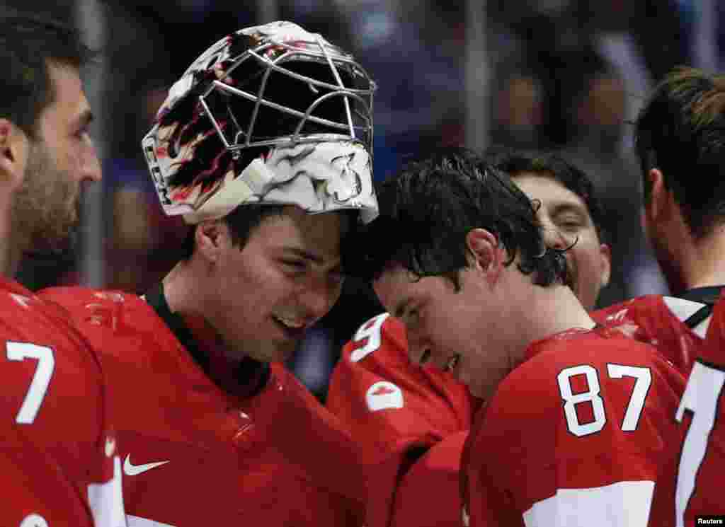 Canada&#39;s goalie Carey Price (left) and Sidney Crosby bump heads after winning their men&#39;s ice hockey gold medal match against Sweden. (Reuters/Gary Hershorn)