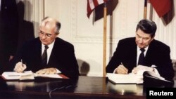 U.S. President Ronald Reagan (right) and Soviet President Mikhail Gorbachev sign the Intermediate-Range Nuclear Forces (INF) treaty at the White House on December 8, 1987.