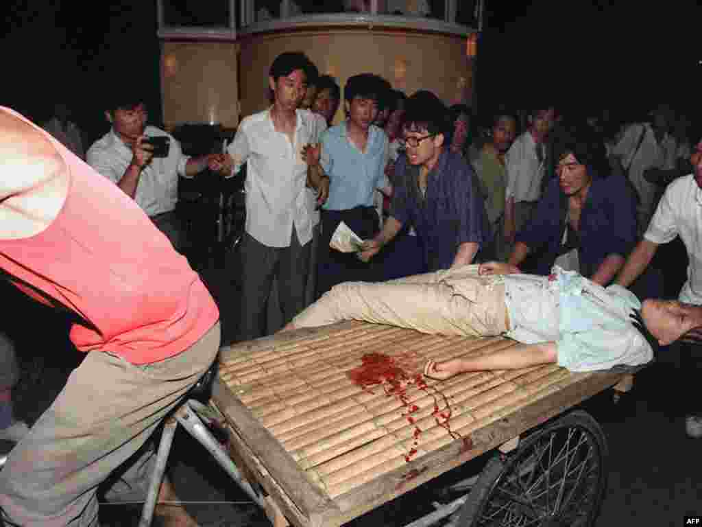 China -- A girl wounded during the clash between the army and students is carried out by a cart, Beijing, 04Jun2009 - CHINA, Beijing : (FILES) This file photo taken on June 4, 1989 shows a girl wounded during the clash between the army and students near Tiananmen Square in Beijing being carried out by a cart. Hundreds, possibly thousands, of protesters were killed by China's military on June 3 and 4, 1989, as communist leaders ordered an end to six weeks of unprecedented democracy protests in the heart of the Chinese capital.