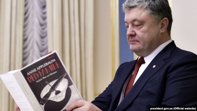 Президент Украины Петр Порошенко листает книгу Энн Эпплбаум «Красный голод: Война Сталина против Украины»