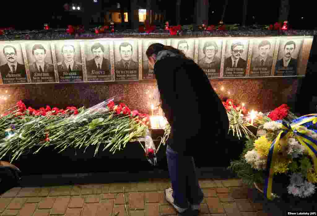 A Ukrainian lights candles to commemorate those who died after the 1986 Chernobyl nuclear disaster, during a ceremony at the memorial to Chernobyl firefighters in the town of Slavutych, Ukraine, on April 26. (AP/Efrem Lukatsky)