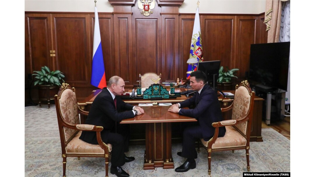 Russian President Vladimir Putin (left) meets with Batu Khasikov at the Kremlin on March 20.