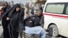 Residents wheel a stretcher carrying a wounded woman after a bomb attack targeted Shi'ite pilgrims commemorating a religious ceremony in Karbala.