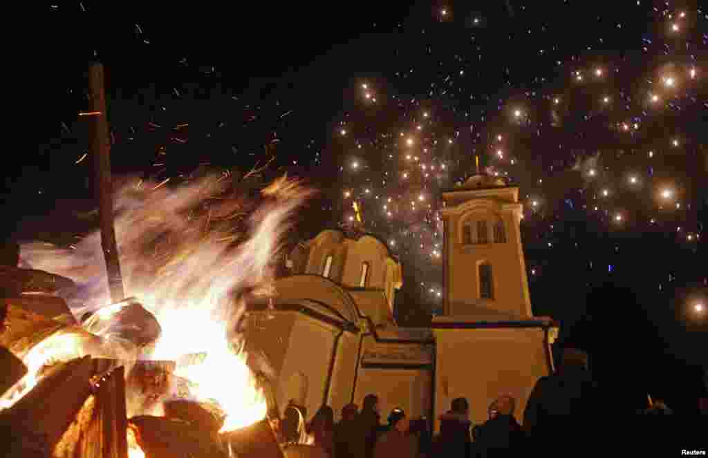 Burning Yule logs and fireworks are seen in front of the Sokolica church on Orthodox Christmas eve, in Ravna Romanija, in Bosnia-Herzegovina.