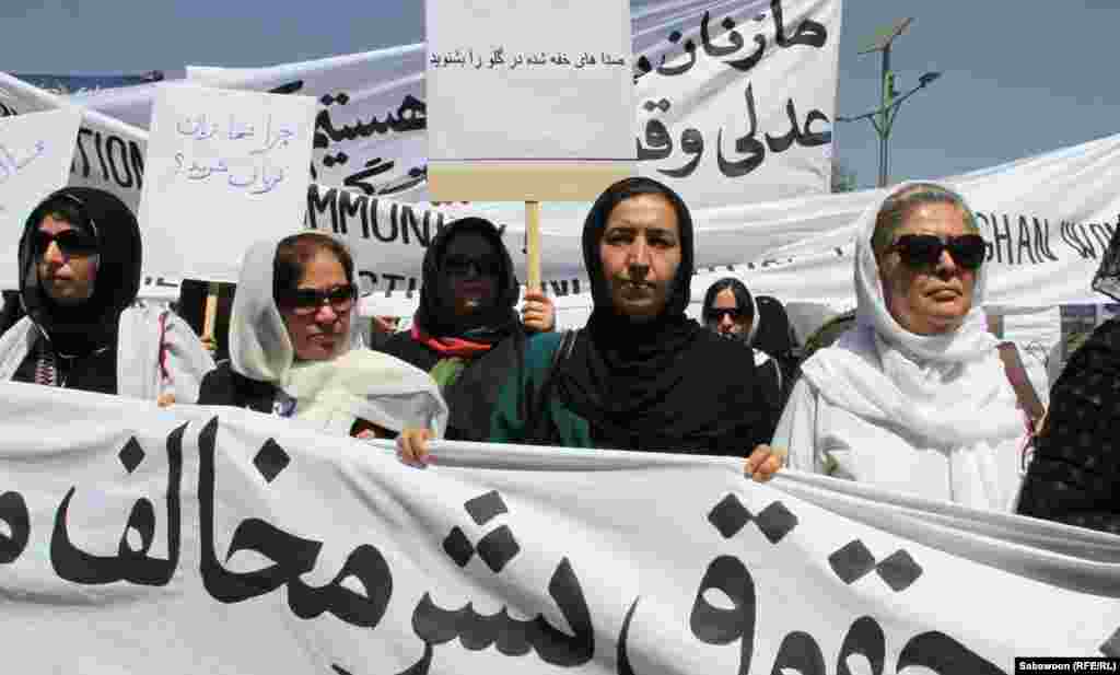 Afghan women march in Kabul on July 11 to protest against the recent public execution of a young woman for alleged adultery. The execution was captured in a shocking video. (RFE/Sabawoon)