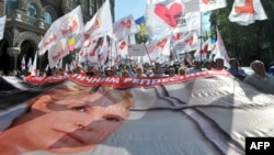 Supporters of jailed opposition leader Yulia Tymoshenko carry a huge poster of her during an opposition rally in Kyiv on April 27.