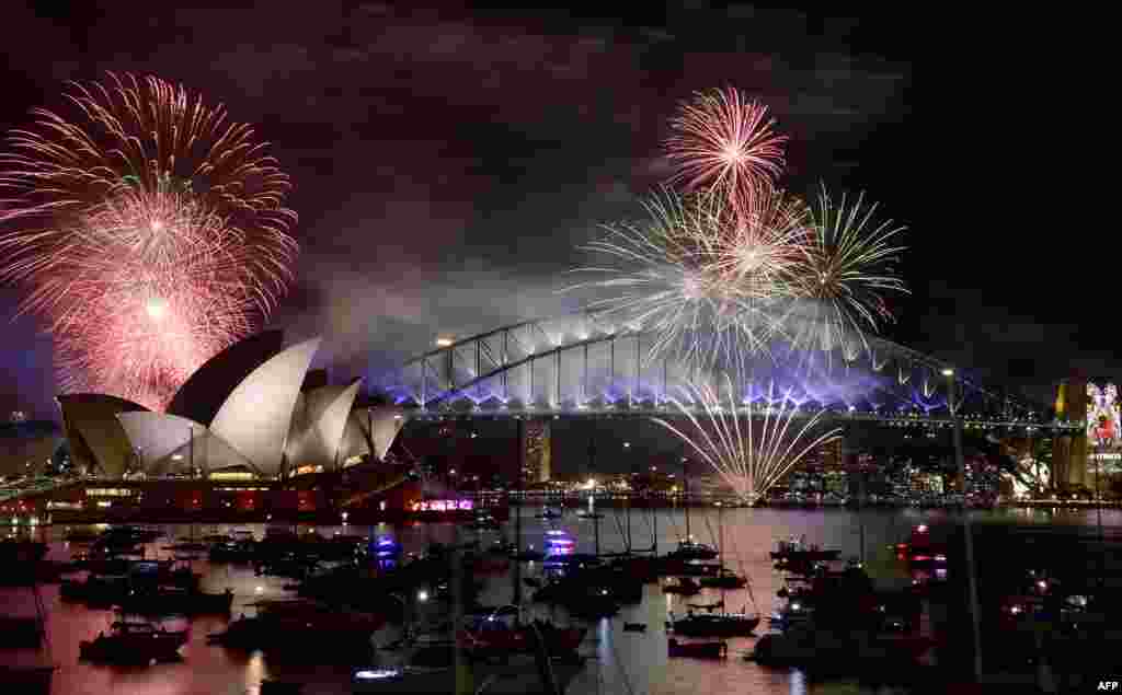 Fireworks light up the sky over Sydney's Opera House and Harbor Bridge during New Year celebrations in Sydney, Australia, on January 1, 2016. (AFP/Saeed Khan)