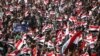 Supporters of Shi'ite cleric Muqtada al-Sadr wave Iraqi flags during a rally in Basra on March 19.