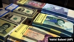 IRAN -- Iranian and U.S. banknotes are on display at a currency exchange shop in downtown Tehran, April 4, 2015