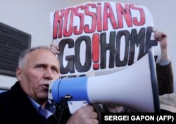 Belarusian opposition figure Mikalay Statkevich speaks during a rally against a Russian military base in Belarus in Minsk on October 4.