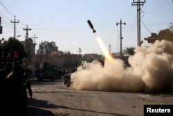 Members of the Iraqi rapid response forces fire a missile toward Islamic State militants during a battle in the Somer district of eastern Mosul on January 11.