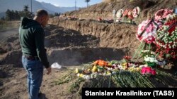 Nagorno Karabakh -- A man stands by his son's grave at a memorial cemetery, in Stepanakert, November 27, 2020.