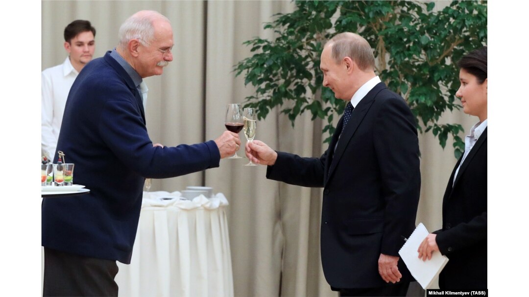 Russian film director Nikita Mikhalkov (left) enjoys a toast with Russian President Vladimir Putin at the Mariinsky Theatre in St. Petersburg in 2016.