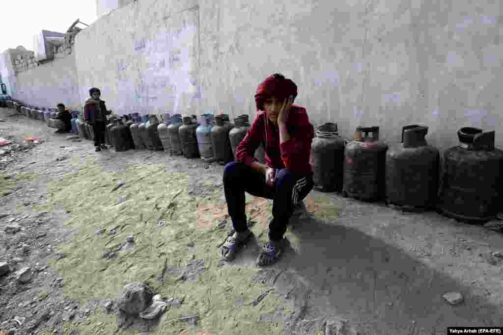 Yemenis wait next to empty cooking cylinders for gas supplies amid increasing gas shortages in Sanaa. According to reports, Yemen continues to experience severe cooking gas shortages since the Saudi-led coalition started a military campaign against the Huthi rebels and their allies in the impoverished Arab state three years ago. (epa-EFE/Yahya Arhab)