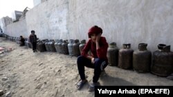 Yemenis wait next to empty cooking-gas cylinders for gas supplies amid increasing gas shortages in the capital, Sanaa, last month.