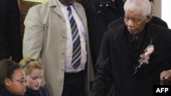 South African ex-President Nelson Mandela (right) arrives at a June 2010 memorial for a great-granddaughter killed in an car accident.