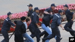 Belarusian policemen detain protesters during a demonstration in Minsk last month.
