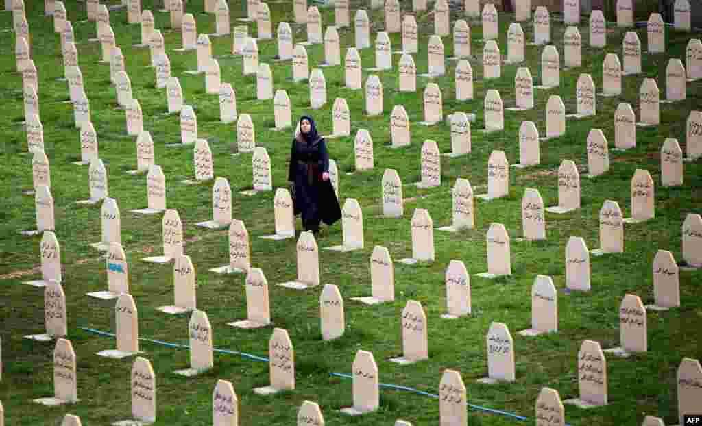 An Iraqi Kurd woman visits a graveyard for the victims of a gas attack by former Iraqi President Saddam Hussein in 1988, as people mark the 26th anniversary of the attack in the Kurdish town of Halabja on March 16. (AFP/Safin Hamed)