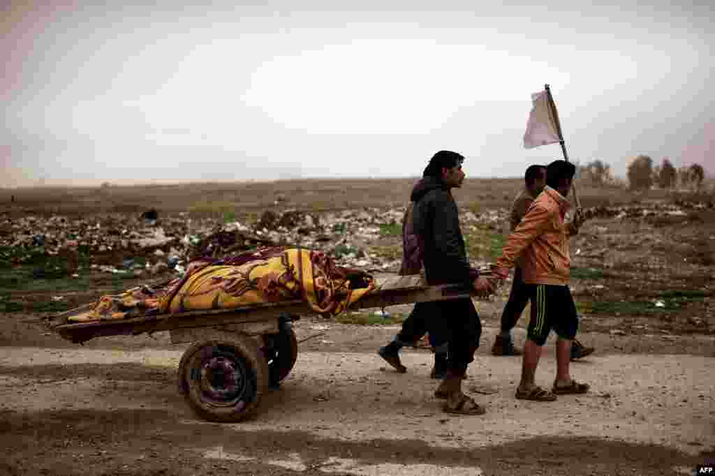 Relatives transport the bodies of loved ones from western Mosul, killed in what they say was an air strike targeting Islamic State militants. (AFP/Aris Messinis)