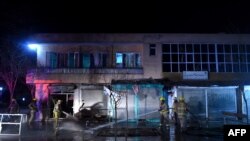 fghan firefighters hose down the site of a suicide attack targeting lawmaker Gul Pacha Majidi in Kabul on March 29.