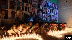 Pakistani residents place candles at the site of a suicide bombing the day before at the Civil Hospital in Quetta on August 9.