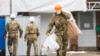 U.K. -- Army officers wearing combat uniform are seen carrying bags after removing what is believed to be part of the roof at the house of former Russian spy Sergei Skripal in Christie Miller Road in Salisbury, February 4, 2019